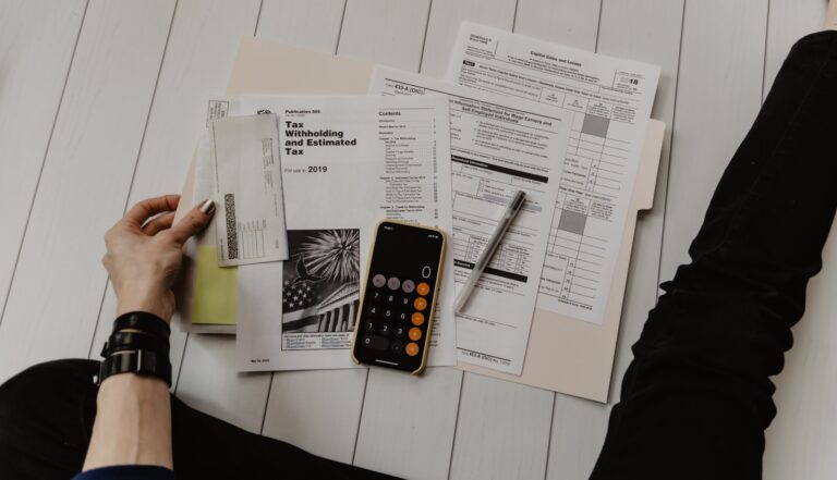 Cards, documents, and a pen on a table, representing credits, accumulated value, and reward systems.