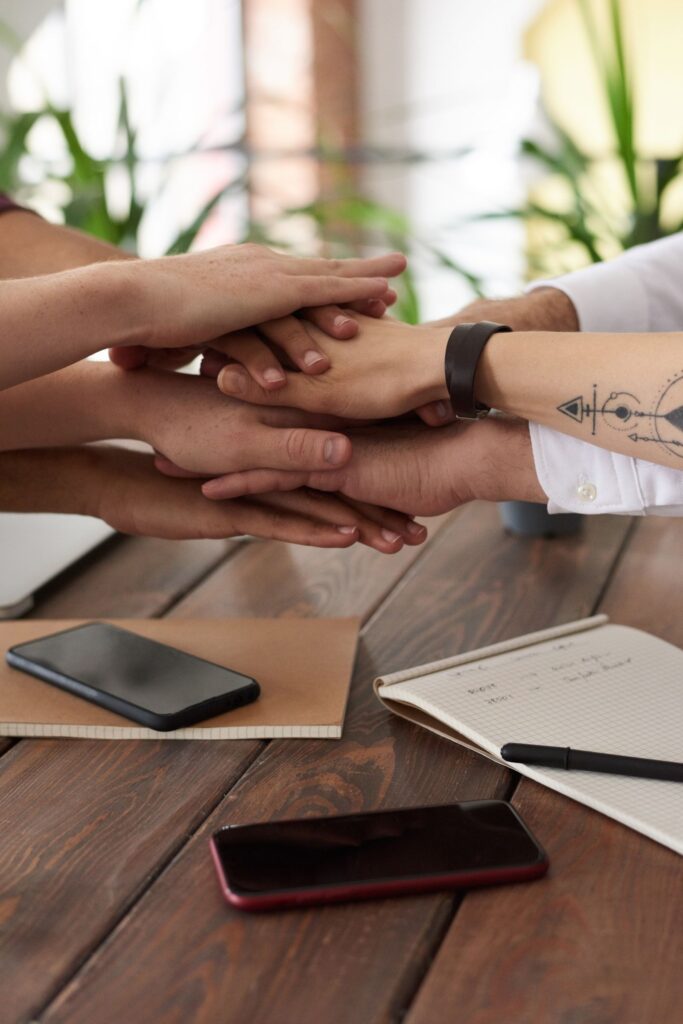 People in a digital community working together in front of a computer, representing a community that creates trust signals for humans and AI agents.