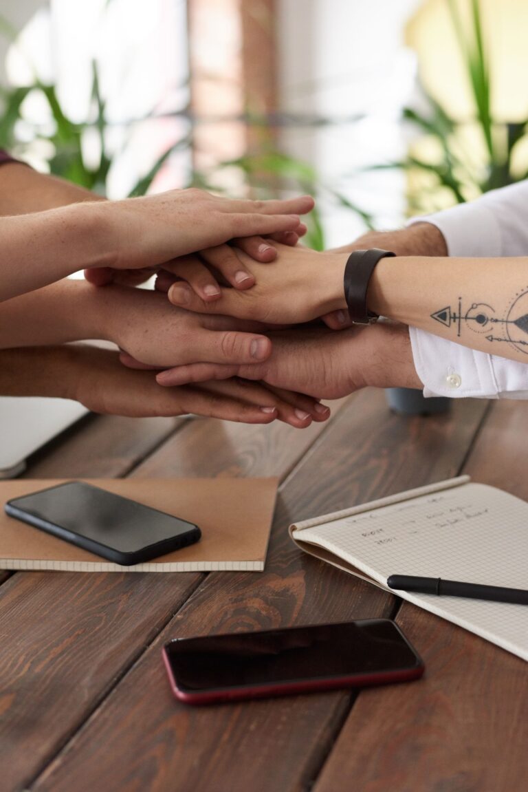 People in a digital community working together in front of a computer, representing a community that creates trust signals for humans and AI agents.