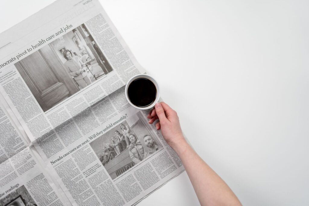 A person reading news on a phone, representing curiosity, recurring updates, and content that brings audiences back.