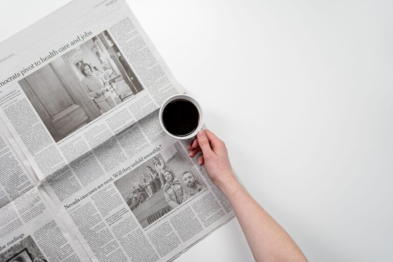 A person reading news on a phone, representing curiosity, recurring updates, and content that brings audiences back.