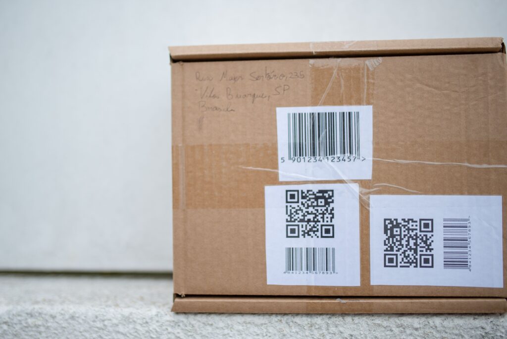 Cardboard packages with barcodes and QR codes as a metaphor for machine-readable data in a physical business