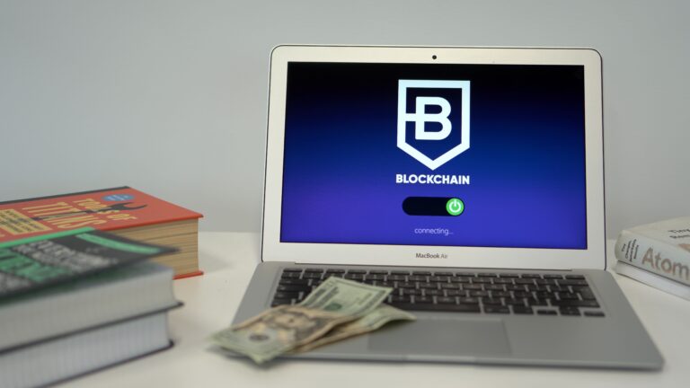 A laptop showing a blockchain network illustration as a metaphor for a decentralized internet and a digital trust layer