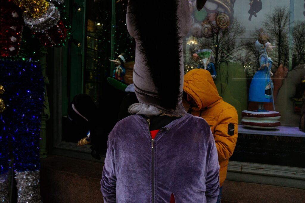 A person in a mascot costume in front of a storefront as a metaphor for a brand character giving a product a face and personality