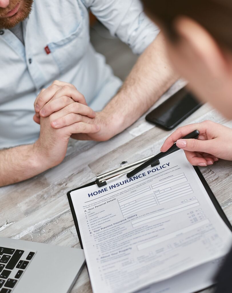 Two people reviewing an insurance document on a table as a metaphor for a serious product that humor can make more approachable