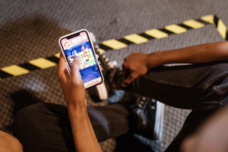 A person playing a colorful game on a phone as a metaphor for a call to action becoming playful participation